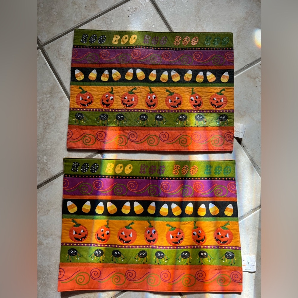 Two vintage Halloween seasonal decorative placemats with pumpkins candy corn